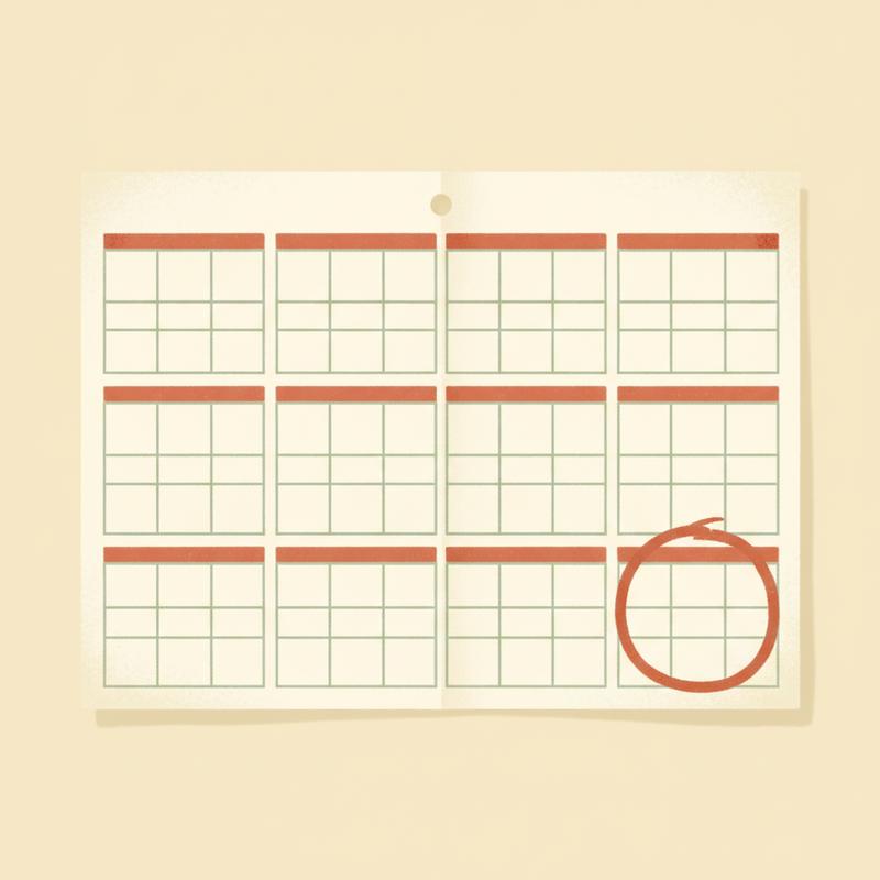 A wall calendar showing a year of empty squares with a single square near the end circled in thick marker